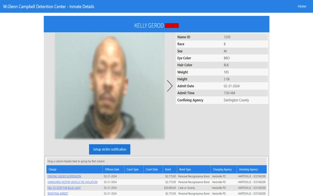 A screenshot from the Darlington County Detention Center displaying an individual's mugshot, alongside personal information such as name ID, race, sex, eye color, hair color, weight, height, and admission details, as well as a list of charges with offense dates, court type, court dates, bond amounts, and agencies involved.